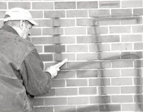 5.16.22 LC Business Owner Cleaning Swastika Graffiti.jpg